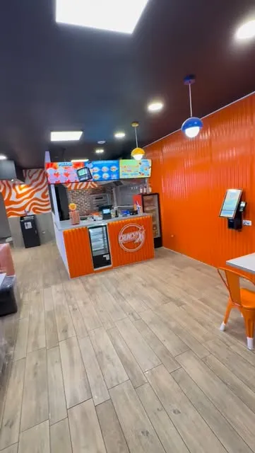 La salle du restaurant, murs orange et comptoir Crunchy X